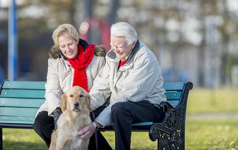 couple sitting on a bench outside in winter