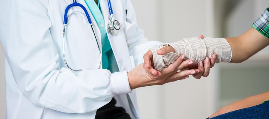 Doctor wrapping a patient's injured wrist