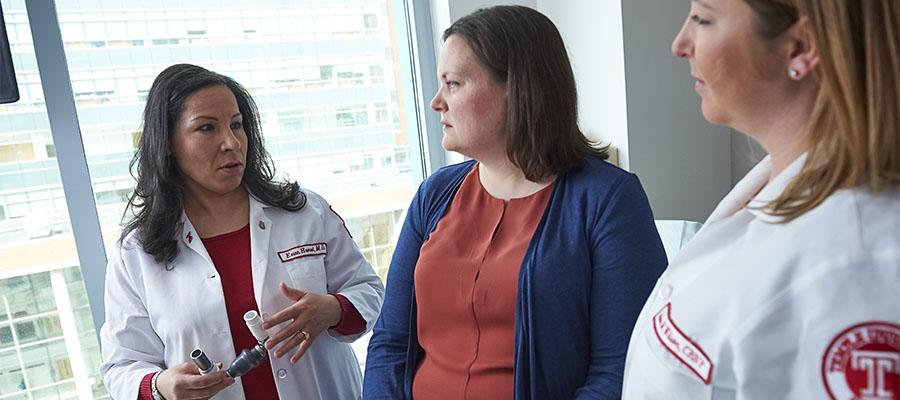 Dr. Eman Hamad showing patient a ventricular assist device (VAD)