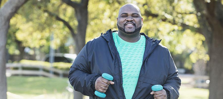 Man exercising with weights outside