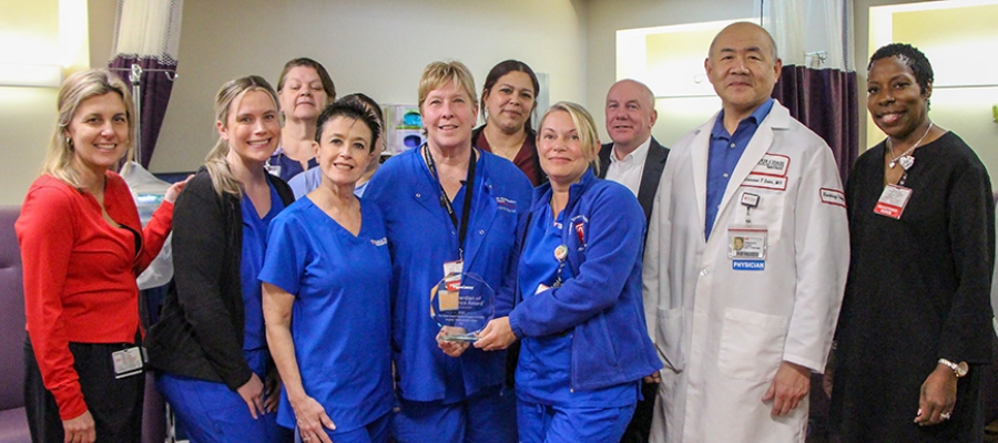 Group of Healthcare Providers Posing with Press Ganey Award for Excellence