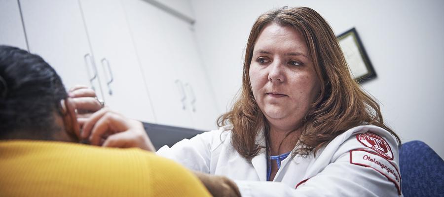 Otolaryngologist checking patients ear