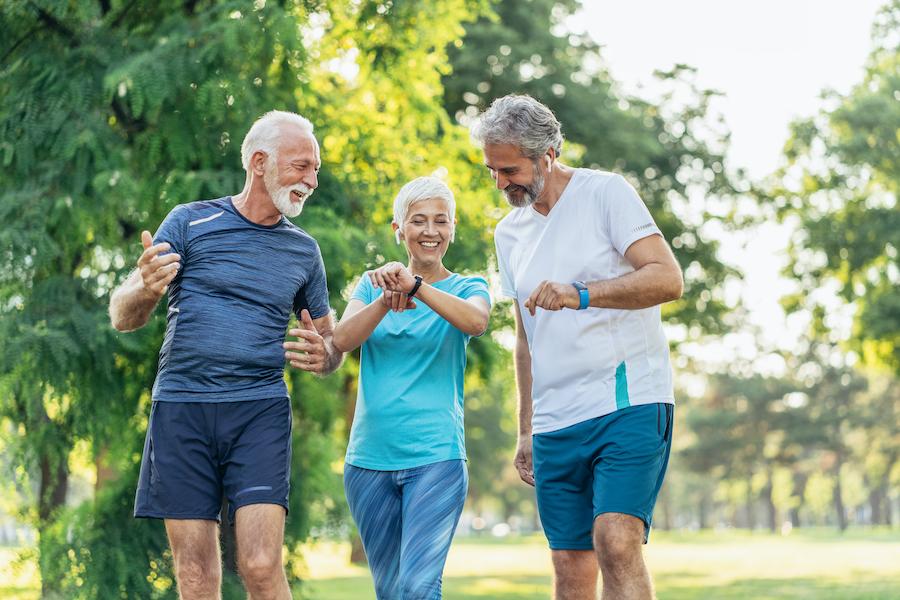 adults on a walk checking fitness watch