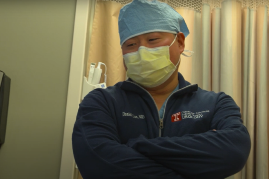 Dr. Daniel Eun in a surgical mask in an OR prep area