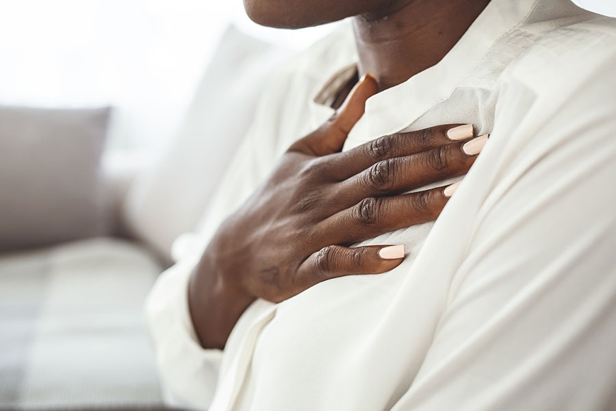 Closeup of woman holding chest