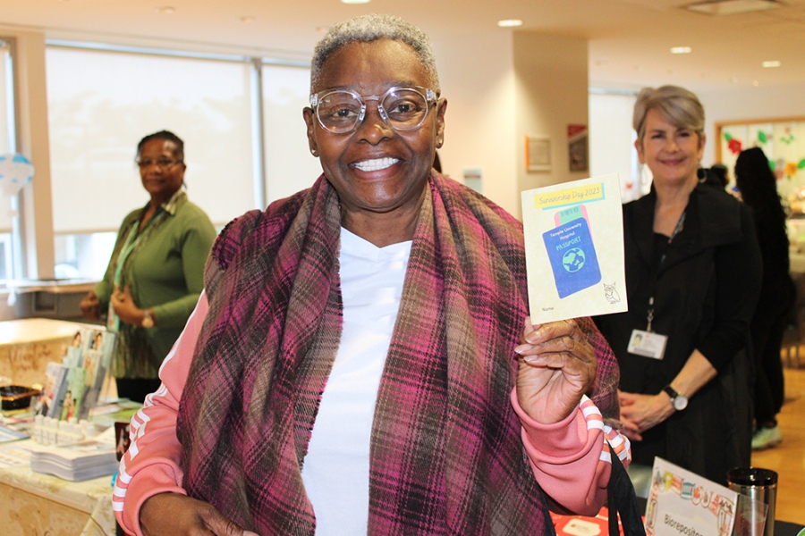 Woman holding up literature about survivorship.