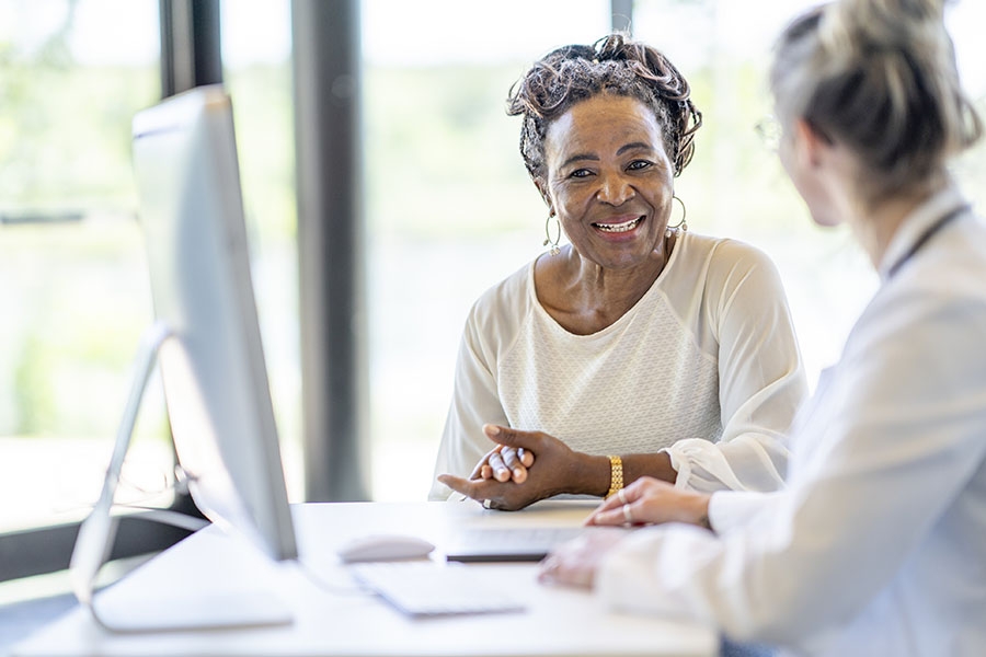 Woman discussing clinical trial with doctor