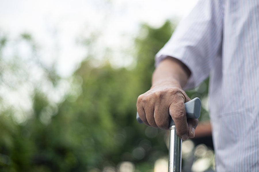 Closeup man holding cane