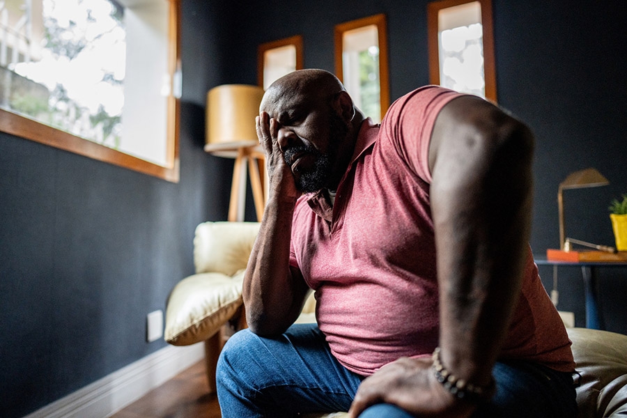 Tired man holding his head