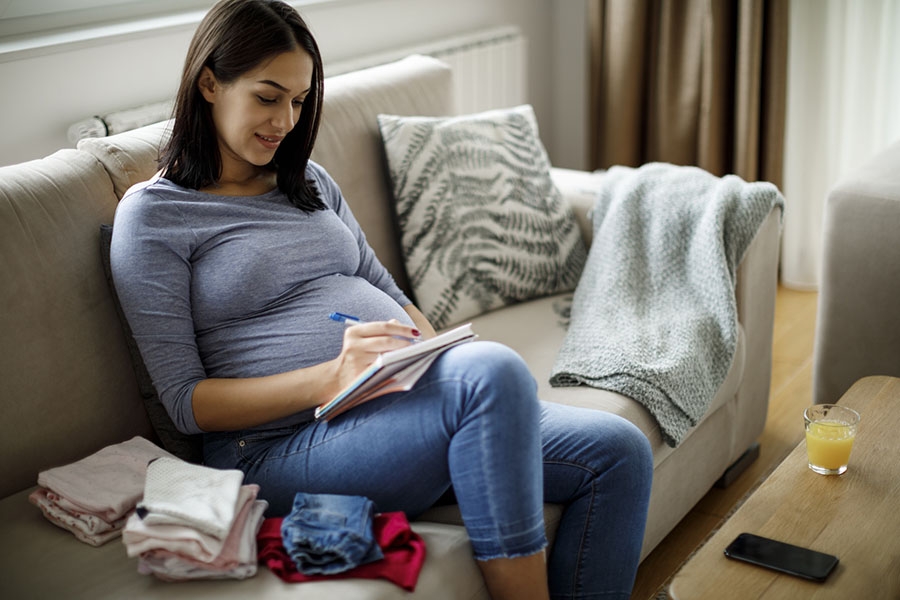 Pregnant woman writing birth plan