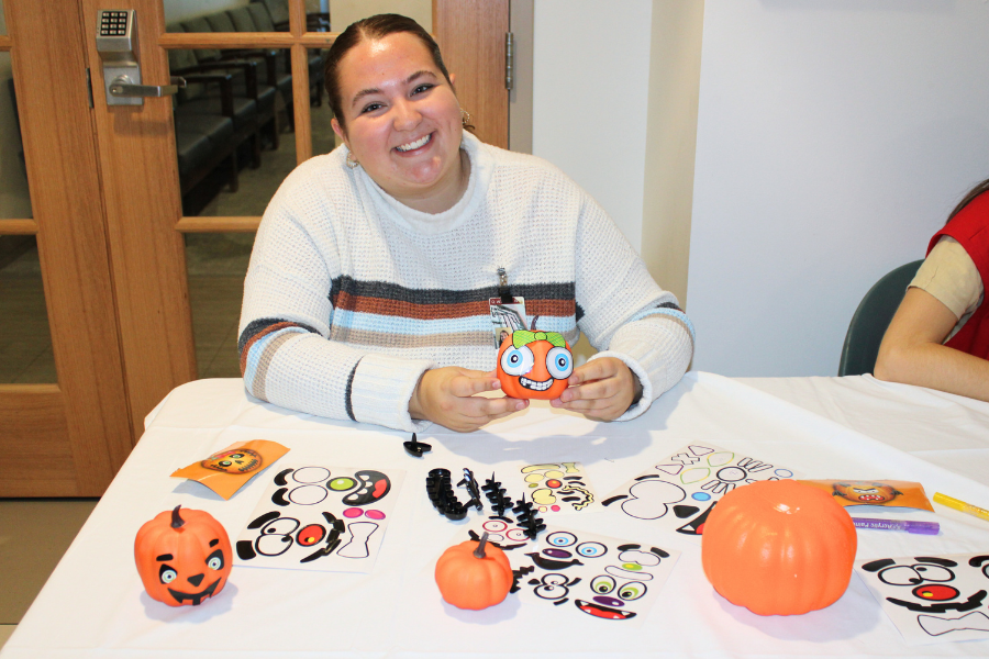 One of our event volunteers with a pumpkin she decorated.
