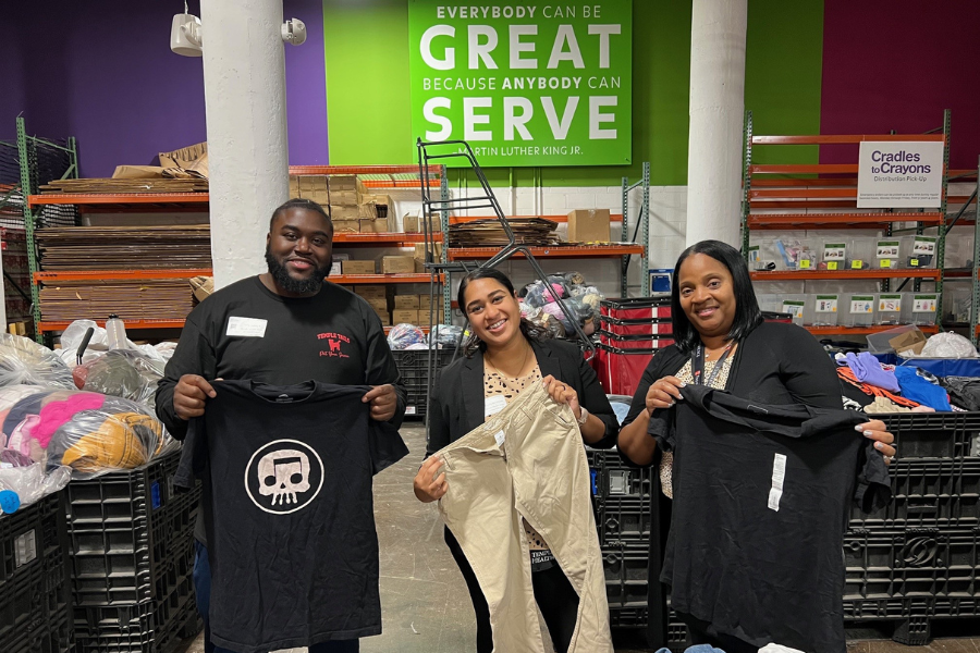 Patient Experience team members help pack donations for distribution.