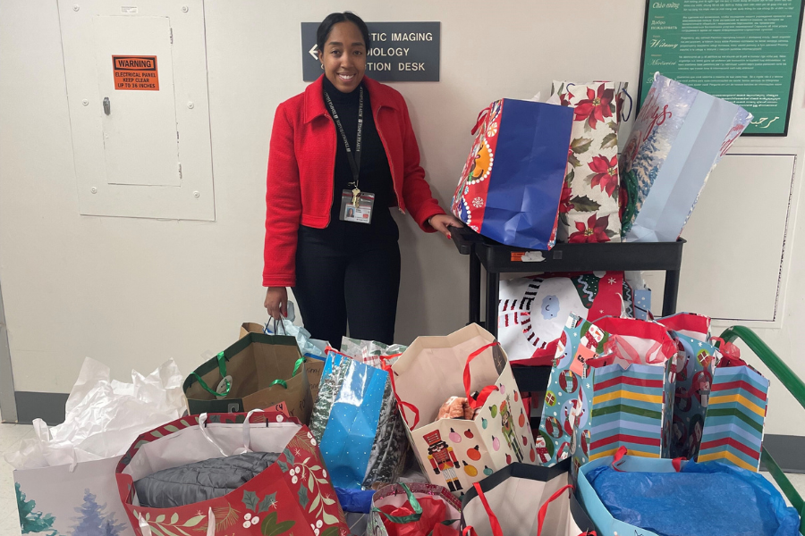 Briana Stinson, LCSW, Episcopal's Director of Therapeutic Programming, with gifts for the Adopt-a-Patient celebration.