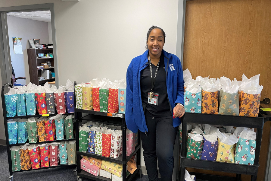 Stinson with the finished gift bags to be distributed to Episcopal patients on Christmas.
