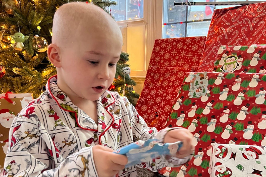 Gavin opening one of his presents from Santa (aka 3 East, 4 East, and 4 West).