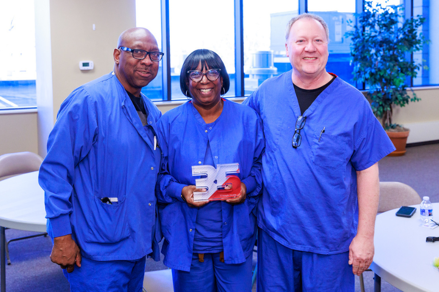 Unit Supply Coordinator Dawn Jamison (center) and two of her colleagues celebrate her 35 years at Chestnut Hill Hospital.