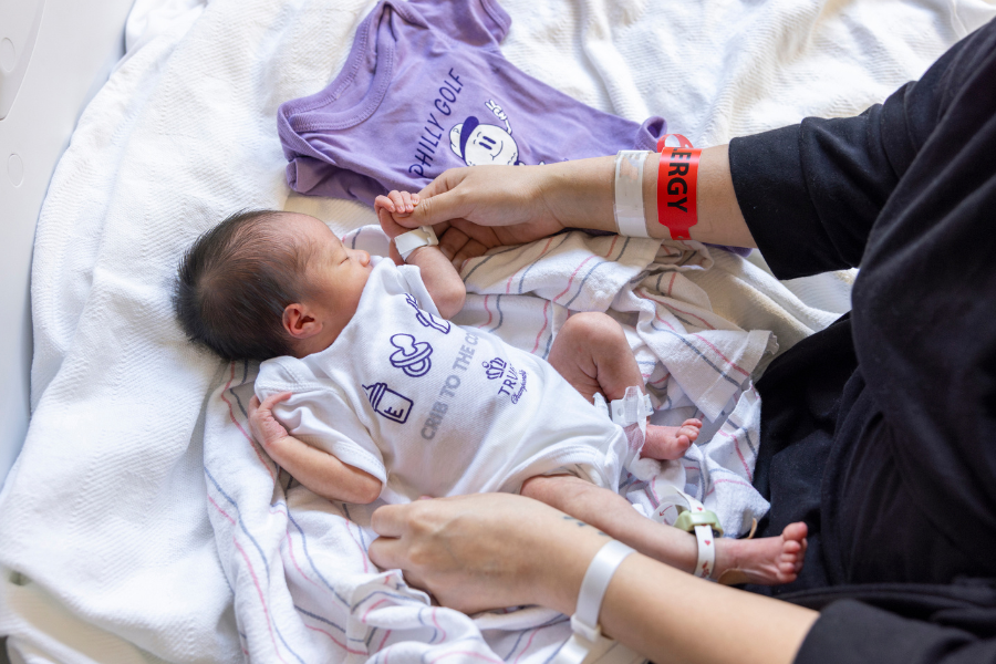 One of the babies born at Temple Health during tournament week that golfer Tony Finau and his wife Alana visited, wearing a gifted Truist Championship onesie.  