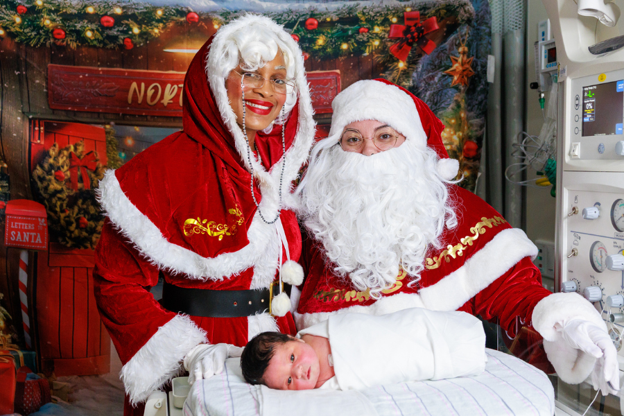 Santa and Mrs. Claus with newborns and their families at Temple Women & Families Hospital.