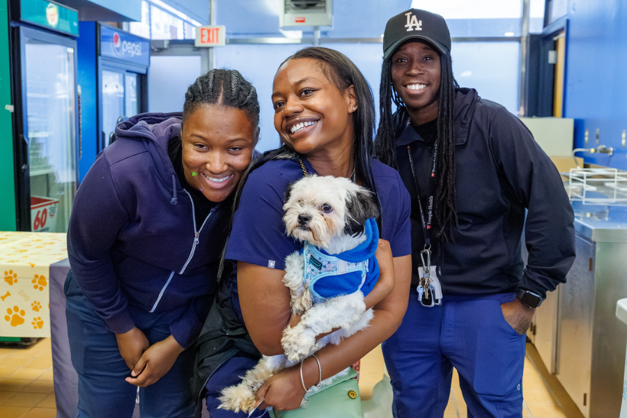 Having a delightful moment, posing with a playful dog for the camera