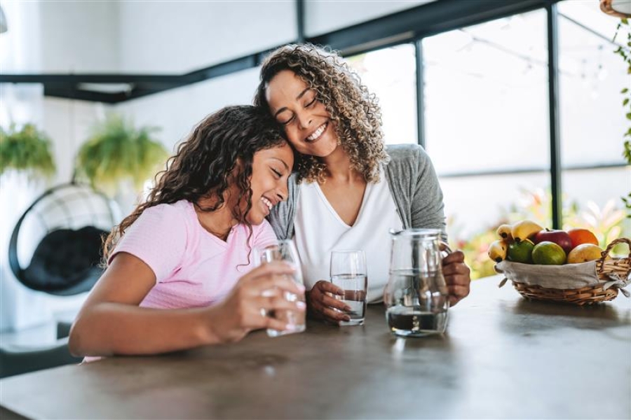 Cheerful parent and child enjoying water with each other.