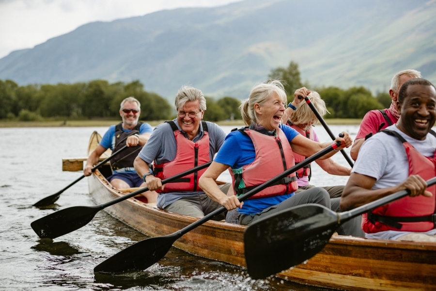 Seniors having fun in a rowing boat