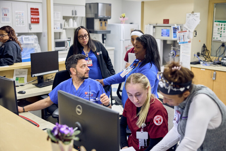 nurses gather around compter
