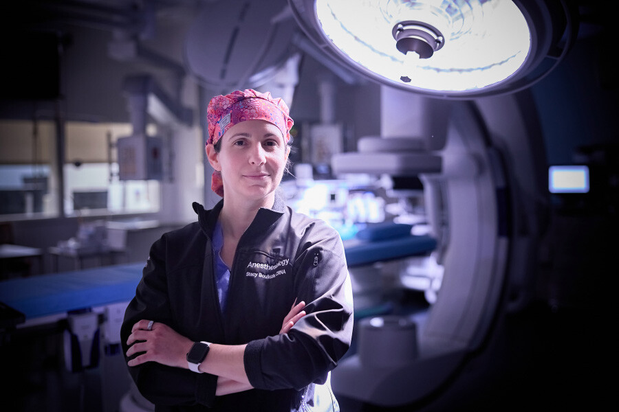 Dr. Stacy from Temple Health looks at camera in front of surgical table