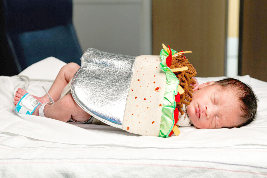 Newborn baby in burrito costume