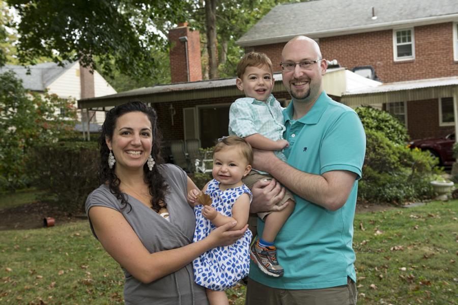Temple patient, Andrew, and his wife holding their kids and smiling outside