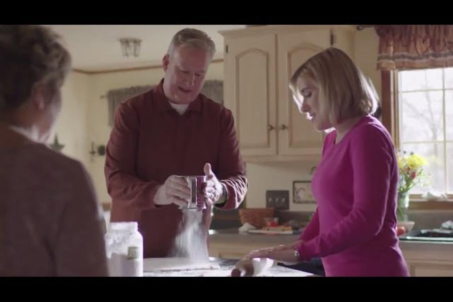 Temple patient, Michael, baking in the kitchen with his family