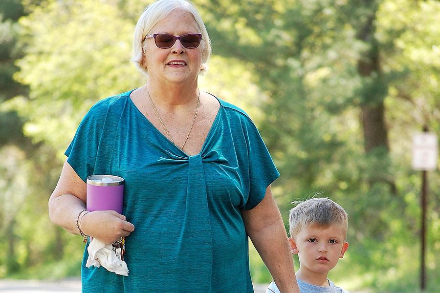 Temple patient Kim walking with her grandson