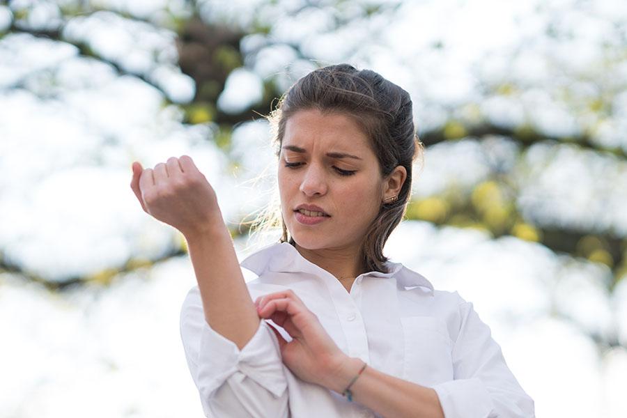 Woman itching dry skin outside