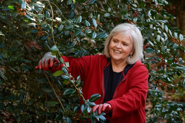 Joann cutting trees in her garden