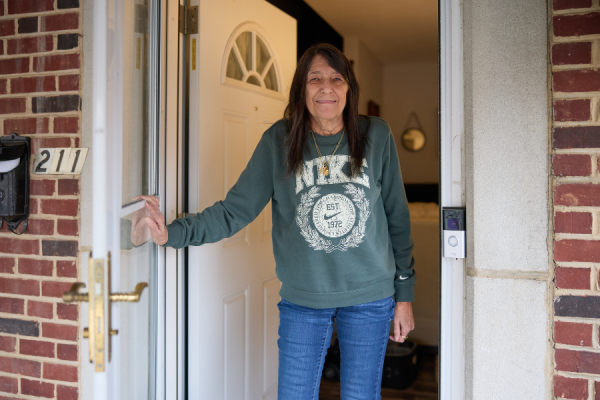 Sharon walking outside of her house