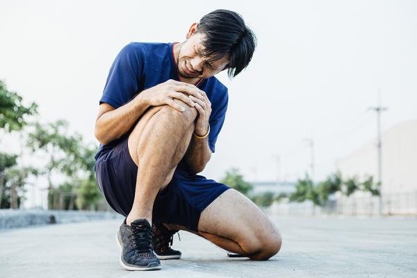 Man holding his knee in pain