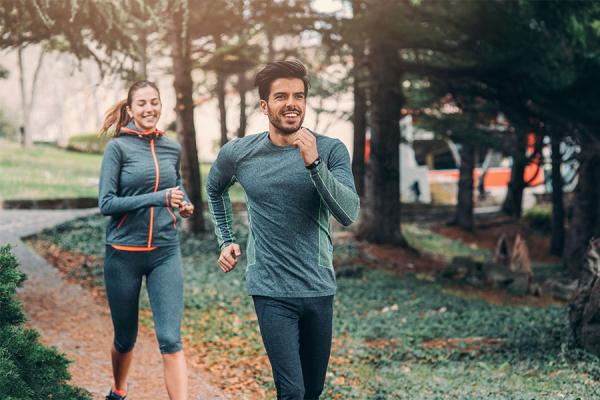 Two athletes jogging through the park