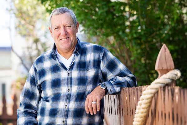 Steve D. leaning against his fence