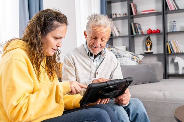 Father and daughter researching COPD on an iPad at home