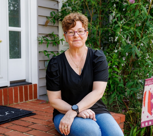 Robin sitting on her front porch