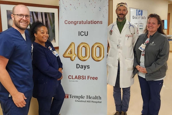 Members of the ICU team with their banner.