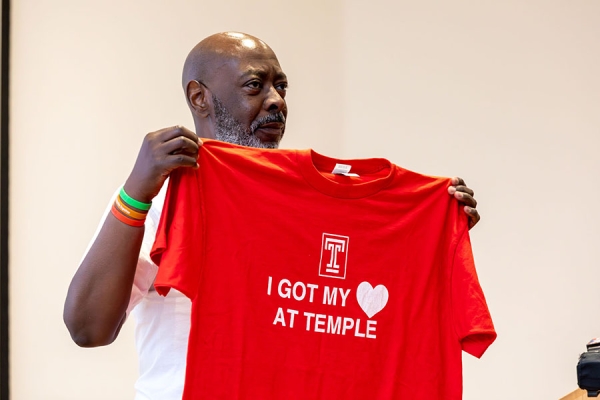 Patient holding up Temple Health shirt