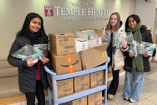 Members of the Temple University Pre-Dental Health Society with some of the 540 approximately 540 dental hygiene kits they assembled to be donated to TUH-Main Campus patients and community members.