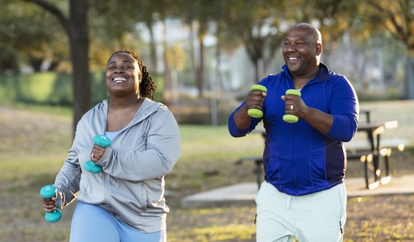 Couple exercising in park with hand weights
