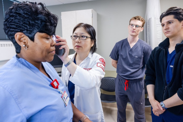 Dr. Hsu examines a Temple Health employee’s face at the screening.