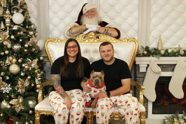 Amber, Kyle, and Mac get a photo with Santa.