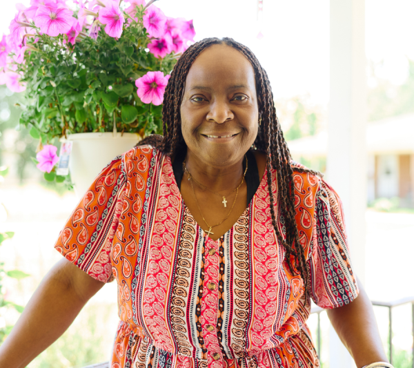 Sheila outside smiling on her porch
