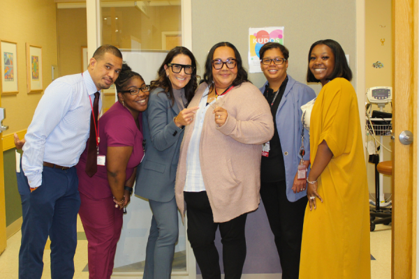 Josephine Balderas (center) celebrates her TFP C.A.R.E.S Award with her colleagues.
