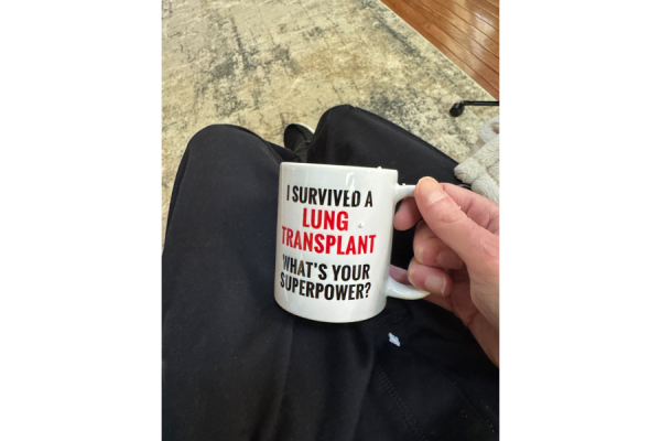 John holds his new coffee mug.