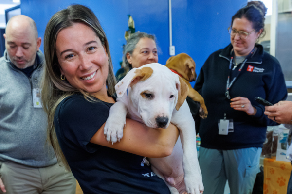 An Episcopal employee with one of the puppies Mathew rescued.