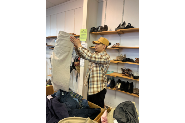 Berrios sorts clothing donations at Greene Street.